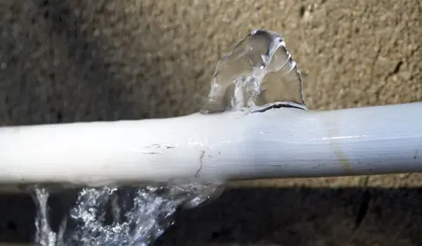 Water pooling from a burst supply pipe in a Denham Springs home