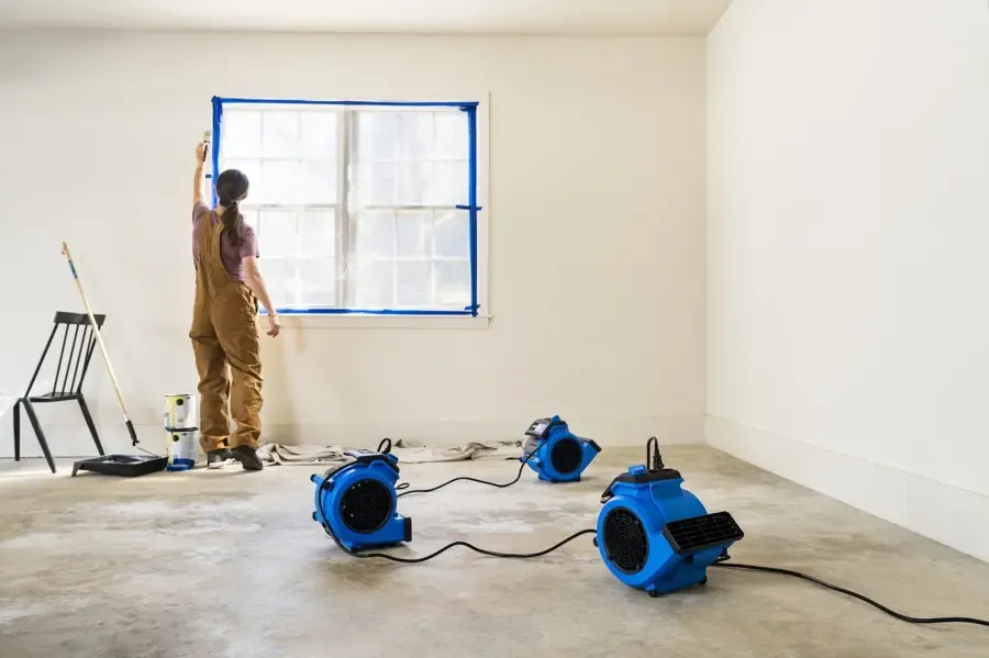Dehumidifier and air movers drying framing in a Denham Springs home